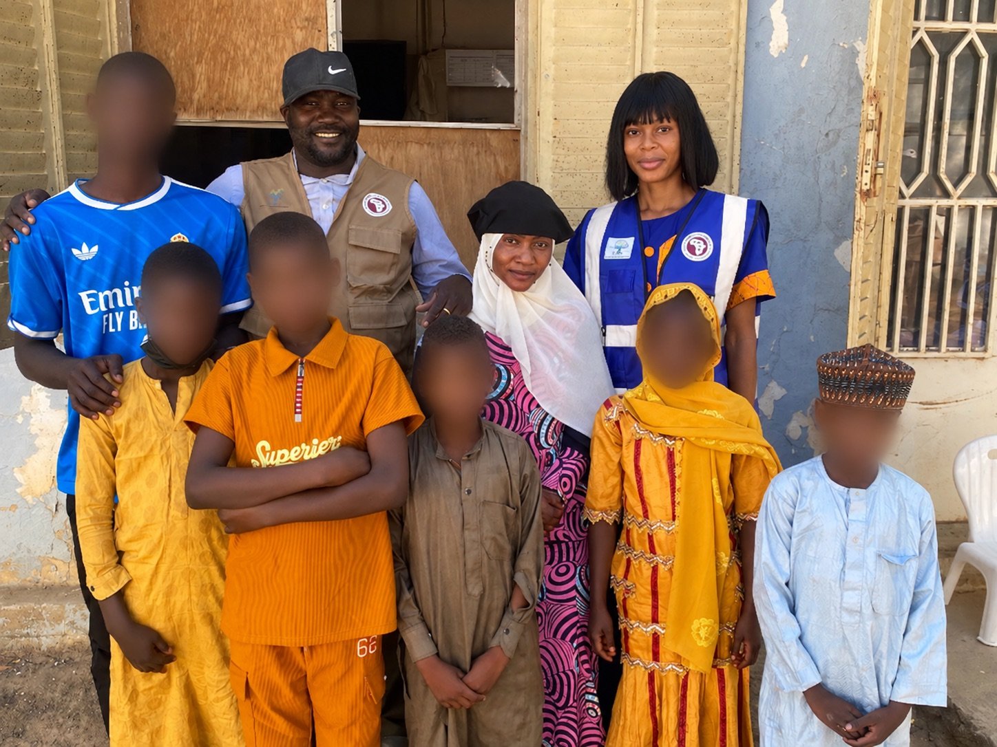 Group photograph from the Kousseri project report, with six young faces blurred to protect privacy